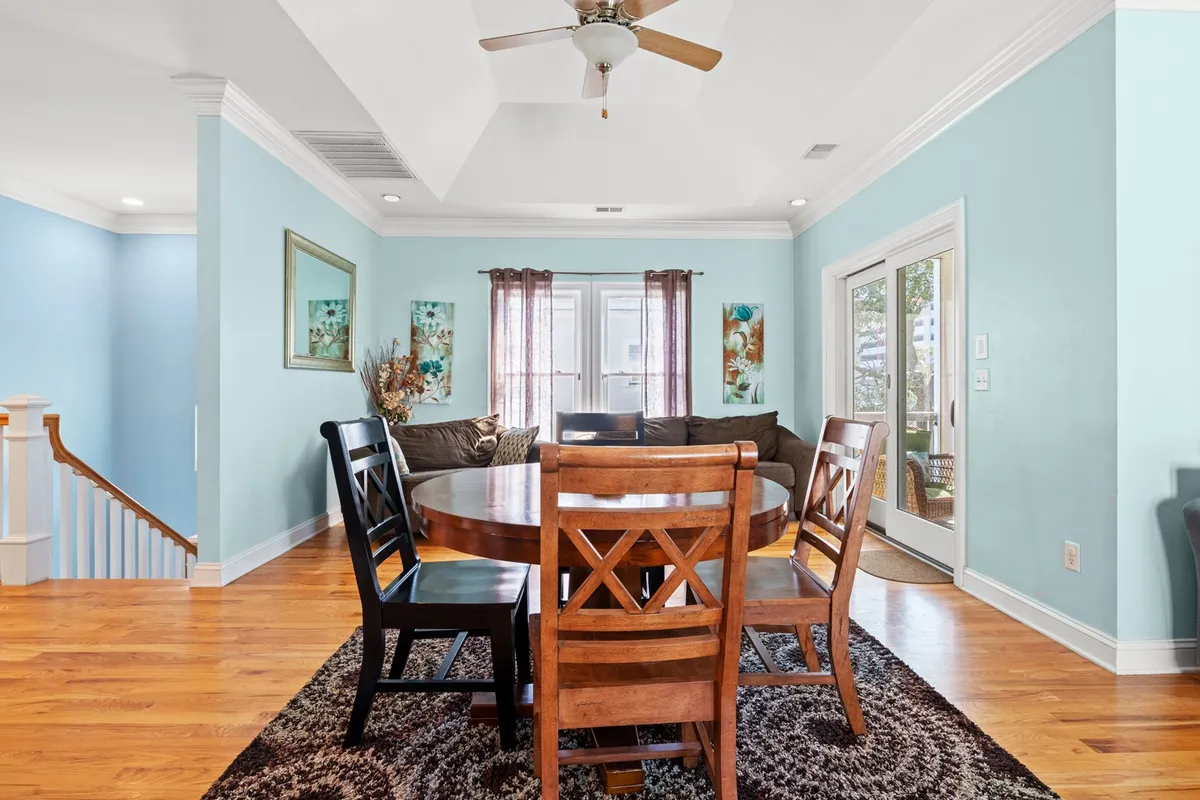 A welcoming common area featuring a dining table, a sofa that can be used as a queen sleeper, and attractive decorative wall art. The space is inviting and multifunctional, ideal for social gatherings or accommodating extra guests.